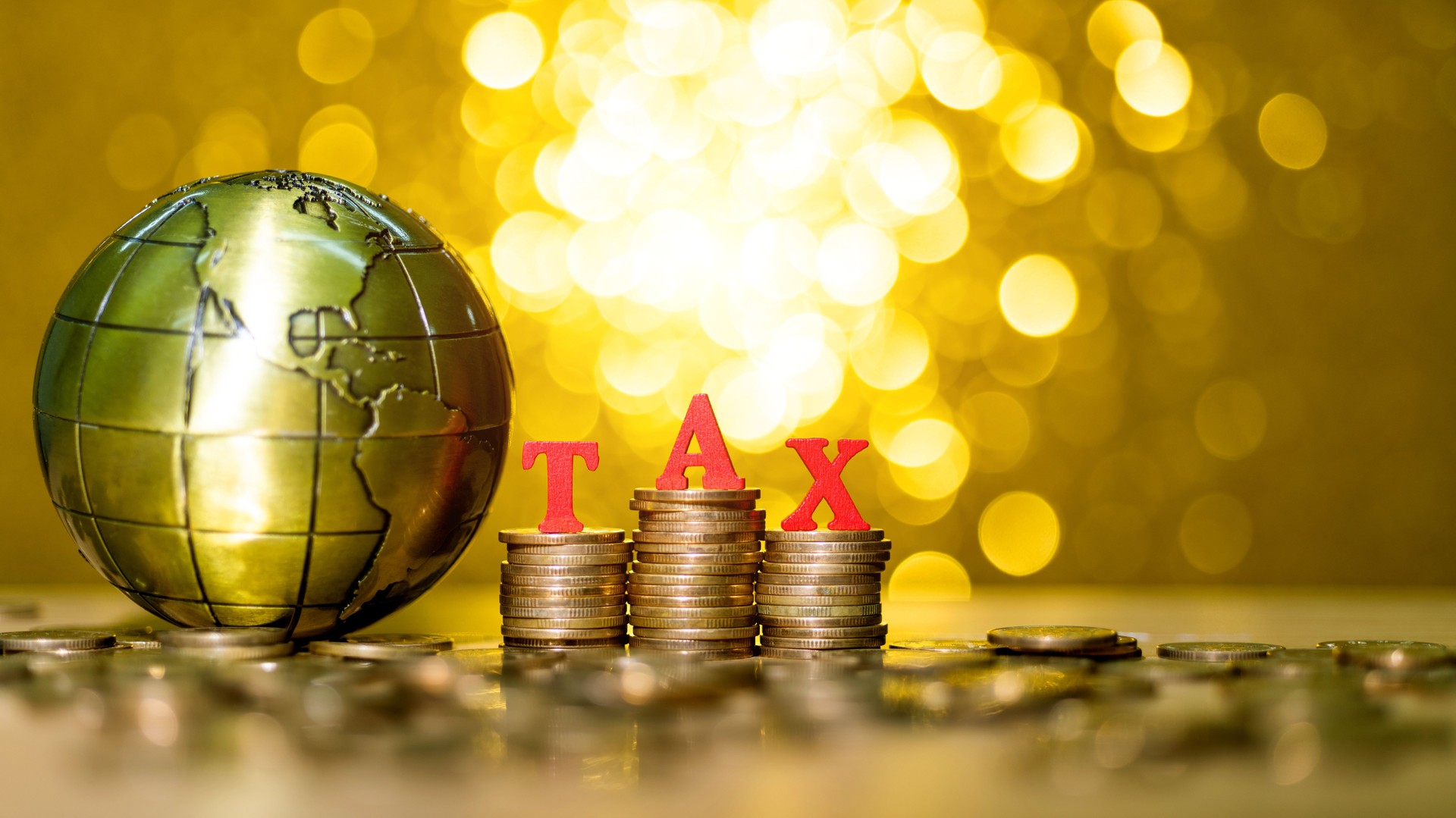 Tax coins and global on shiny golden background